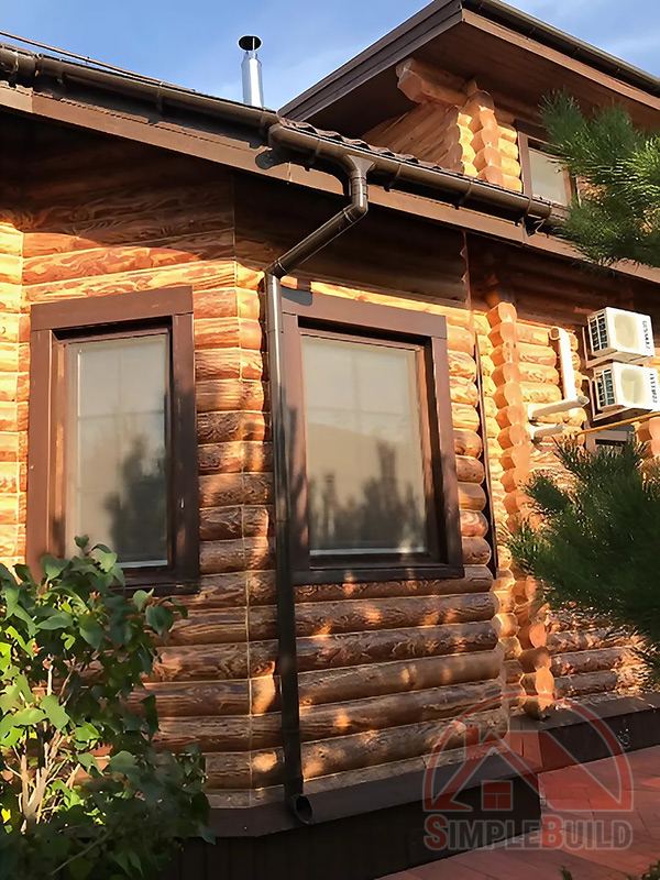 Водосточная система Дёке Люкс шоколад на бревенчатом доме